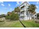 Three-story building exterior, gray siding, and palm trees at 2262 Folly Rd # 2-K, Charleston, SC 29412