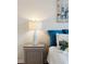 Bedside table with lamp and plant in a bedroom with teal pillows at 232 Mallory Dr, Charleston, SC 29414