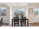 A dining table with four chairs is situated by a window overlooking the backyard at 232 Mallory Dr, Charleston, SC 29414