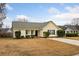 Charming yellow house with a green roof, well-maintained lawn, and a driveway at 232 Mallory Dr, Charleston, SC 29414