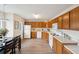 Eat-in kitchen featuring wood cabinets, white appliances, and hardwood floors at 232 Mallory Dr, Charleston, SC 29414