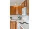 Bright kitchen with wood cabinets, white appliances, and a corner sink at 232 Mallory Dr, Charleston, SC 29414