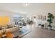 Open living room with hardwood floors, large windows, and a view of the dining area at 232 Mallory Dr, Charleston, SC 29414