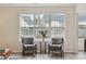 Two gray armchairs sit before a large window overlooking the backyard at 232 Mallory Dr, Charleston, SC 29414