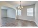 Dining room with hardwood floors, chandelier, and two windows at 238 Wathen Dr, Goose Creek, SC 29445