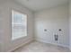 Bright laundry room with window, shelving, and tile flooring at 238 Wathen Dr, Goose Creek, SC 29445