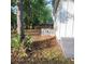 Side view of backyard with some trees, an HVAC unit and grey stairs leading to the home's side entrance at 2664 Hull St, North Charleston, SC 29405
