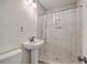 Bathroom with stylish vanity sink, tiled floors, and walk-in shower featuring elegant tiling and convenient recessed shelving at 2664 Hull St, North Charleston, SC 29405