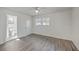 Bright bedroom showcasing hard surface flooring, neutral paint, ceiling fan, and natural light at 2664 Hull St, North Charleston, SC 29405