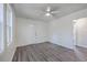 Neutral bedroom features grey floors, natural light, ceiling fan and a wide entrance to the hallway at 2664 Hull St, North Charleston, SC 29405
