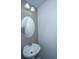 Small bathroom with pedestal sink and round mirror at 275 Jackson St, Goose Creek, SC 29445