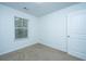 Empty bedroom with neutral walls, carpet, and window with blinds at 275 Jackson St, Goose Creek, SC 29445