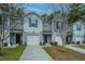 Three townhouses with gray siding and teal accents at 275 Jackson St, Goose Creek, SC 29445