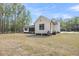 Spacious backyard featuring a lush lawn and a charming screened-in porch, perfect for outdoor entertaining at 3874 Srevir Rd, Johns Island, SC 29455