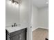 Bathroom vanity featuring dark wood cabinet with marble countertop and chrome hardware at 3874 Srevir Rd, Johns Island, SC 29455