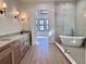 Long bathroom with double vanity and glass shower at 3874 Srevir Rd, Johns Island, SC 29455