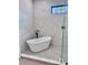 Modern bathroom with freestanding soaking tub and marble tile at 3874 Srevir Rd, Johns Island, SC 29455