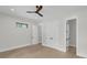 Bright bedroom featuring hardwood floors and neutral walls with closet and bathroom access at 3874 Srevir Rd, Johns Island, SC 29455