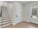 Inviting entryway features wood floors, access to both front and garage doors, and wood stairs at 3874 Srevir Rd, Johns Island, SC 29455
