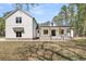 Exterior view of a two-story modern farmhouse with a brick foundation, board and batten siding, and a covered front porch at 3874 Srevir Rd, Johns Island, SC 29455
