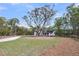 Beautiful home nestled among mature trees, featuring an expansive lawn and a welcoming entrance at 3874 Srevir Rd, Johns Island, SC 29455