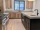 Modern kitchen with island, dark cabinetry, and quartz countertops at 3874 Srevir Rd, Johns Island, SC 29455
