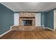 Living room with brick fireplace and hardwood floors at 8626 Vistavia Rd, North Charleston, SC 29406