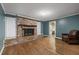 Living room with brick fireplace and hardwood floors at 8626 Vistavia Rd, North Charleston, SC 29406