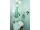 Small bathroom with pedestal sink and round mirror at 104 Pavilion St, Summerville, SC 29483