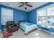 Blue bedroom with double bed, window, and seating at 104 Pavilion St, Summerville, SC 29483