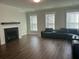 Living room with fireplace, hardwood floors, and black reclining sofa at 106 Helena Park Dr Dr, Summerville, SC 29486