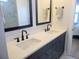 Modern bathroom vanity with double sinks, quartz countertop, and black matte fixtures at 123 Leeward Lndg, Summerville, SC 29486