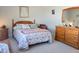 Bedroom with floral bedding, wooden dresser and carpet flooring at 123 Leeward Lndg, Summerville, SC 29486