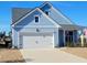 Light blue house with white garage door and American flag at 123 Leeward Lndg, Summerville, SC 29486