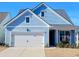 Charming light blue house with white garage door and landscaping at 123 Leeward Lndg, Summerville, SC 29486