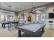 Enjoy the game room with its billiard tables, stylish lighting, and comfortable seating arrangements at 123 Leeward Lndg, Summerville, SC 29486