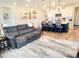 Relaxing living room with gray couch and view of kitchen at 123 Leeward Lndg, Summerville, SC 29486