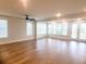 Living room with hardwood floors, neutral walls, ceiling fan, and multiple windows for natural light at 123 Leeward Lndg, Summerville, SC 29486