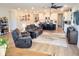 Open living room features hardwood floors, a cozy seating area, and an open concept kitchen at 123 Leeward Lndg, Summerville, SC 29486