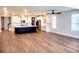 Open living room area featuring an island kitchen with pendant lighting and hardwood flooring at 123 Leeward Lndg, Summerville, SC 29486
