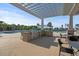 Outdoor kitchen and pool area complete with grill, prep space, and comfortable seating at 123 Leeward Lndg, Summerville, SC 29486