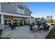 Community patio area with tables, chairs, and outdoor fireplace offering a relaxing gathering space at 123 Leeward Lndg, Summerville, SC 29486