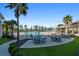 Resort-style pool area with ample seating, palm trees, and outdoor dining space at 123 Leeward Lndg, Summerville, SC 29486