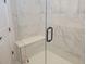 Large shower with glass enclosure, marble tile, and built-in seat at 123 Leeward Lndg, Summerville, SC 29486