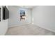 Spacious bedroom with window, neutral carpet, and mounted TV at 134 Vistawood Dr, Charleston, SC 29414