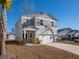 Two-story home with gray siding, white garage door, and landscaping at 134 Vistawood Dr, Charleston, SC 29414