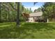 A sprawling backyard features a spacious deck and lush lawn, ideal for relaxation and recreation at 1575 Tacky Point Rd, Wadmalaw Island, SC 29487