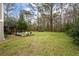 Large backyard with fire pit and seating area at 1575 Tacky Point Rd, Wadmalaw Island, SC 29487
