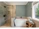 Bathroom featuring a soaking tub, a large walk-in shower, and modern fixtures at 1575 Tacky Point Rd, Wadmalaw Island, SC 29487