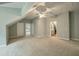 Spacious bedroom with access to bathroom and a ceiling fan at 1575 Tacky Point Rd, Wadmalaw Island, SC 29487